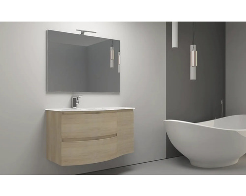 Badrum med tvättställ, spegel och fristående badkar.