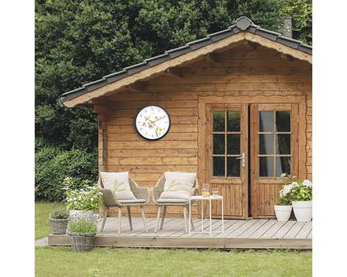 Trädgårdshus med väggklocka, trädgårdsmöbler och dekorationer