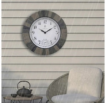 Väggklocka med termometer på en terrass med möbler