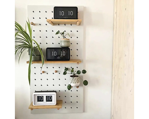 Vägghylla med perforerat mönster, trähyllor, krukväxter och klockor