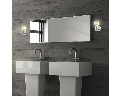 Badrum med dubbla handfat, spegel och två lampor