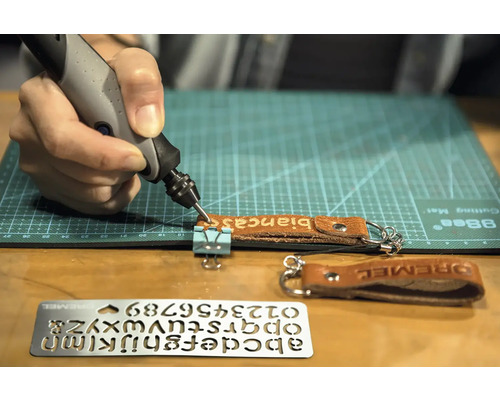 Dremel graveringsverktyg graverar en läderbricka med namnet Bianca, mall för bokstäver och siffror på bilden