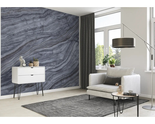 Vardagsrum med marmortapet, fåtölj, golvlampa, matta och byrå