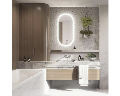 Modernt badrum med tvättställ, spegel med belysning, armatur och förvaringsutrymme