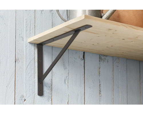 Metallhylla med hylla på en vägg