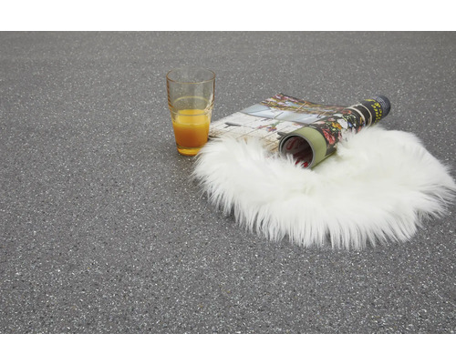 Miljöbild med glas apelsinjuice, tidskrift och fårskinnsmatta