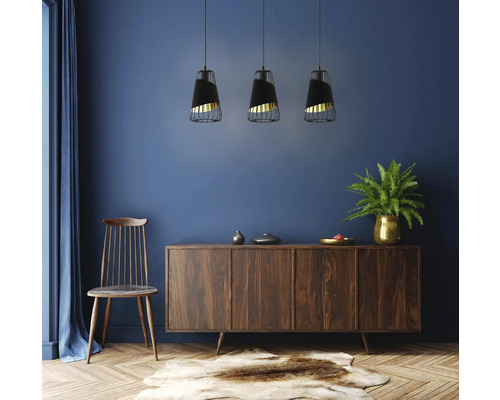 Vardagsrum med byrå, stol och tre hängande lampor