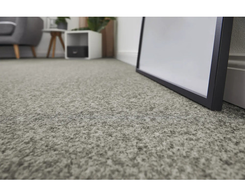 Närbild av en grå matta i ett vardagsrum.