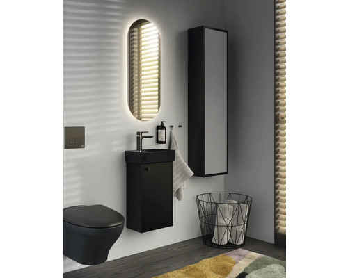 Modernt badrum med svart toalett, tvättställ, spegel och högskåp för en stilfull atmosfär.