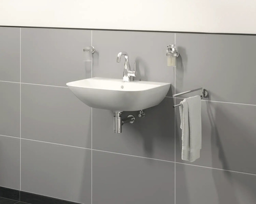 Modernt badrum med handfat, blandare, tvålpump och handdukshängare på väggen.