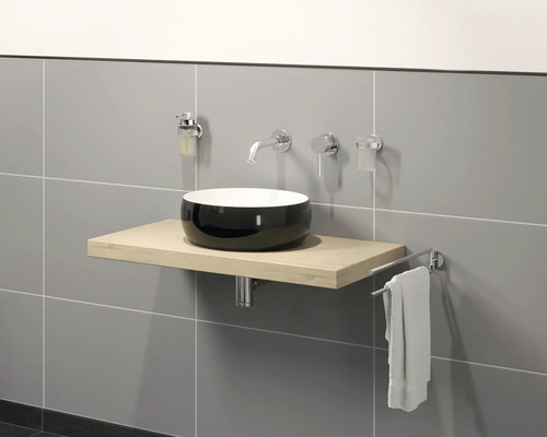 Modernt badrum med tvättställsskål, tvättställsplatta, blandare och handdukshållare