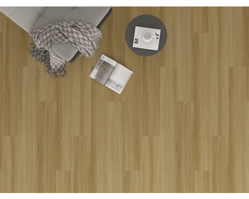 Interiörbild med golvbeläggning, fåtölj, filt, bord och tidskrift