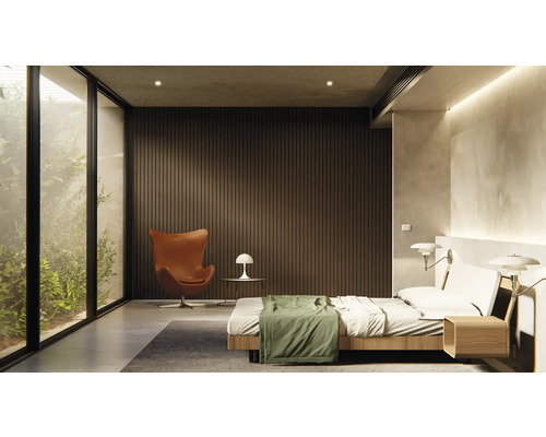 Ljust sovrum med säng, fåtölj och stort fönster med utsikt över grönska