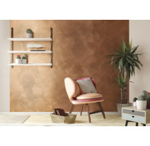 Vardagsrum med brun väggdesign, hylla, fåtölj, krukväxt och sidobord.