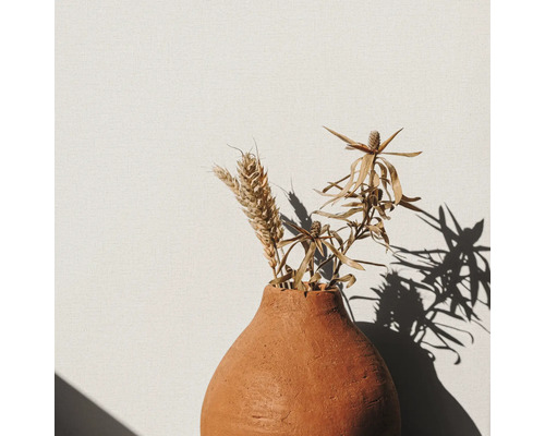 Dekorativa spannmålsstrån och grenar i en keramikvas