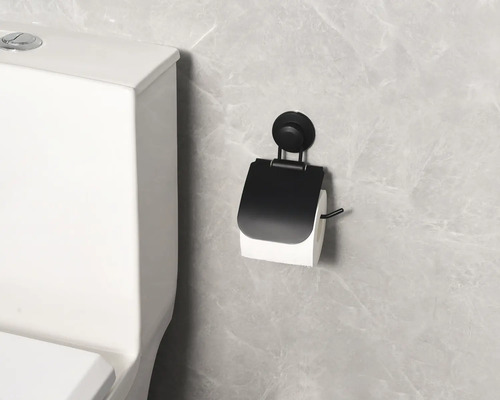 Toalettpappershållare med sugpropp bredvid toalett