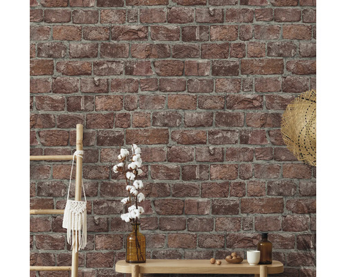 Vägg med tegel tapet och dekorativa element som stege, väska, hatt, vas och bord