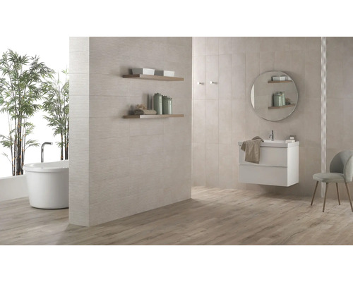 Ljust badrum med badkar, tvättställ och väggplattor