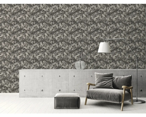 Dekorativt vardagsrum med mönstrad tapet, betongbyrå, lampa och fåtölj