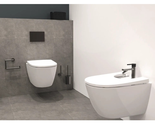 Modernt badrum med vägghängd toalett och bidé, armatur och matchande tillbehör.