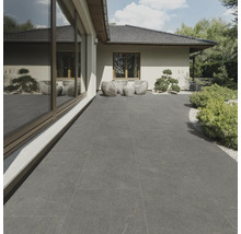 Terrass med grå plattor och sittgrupp i trädgården