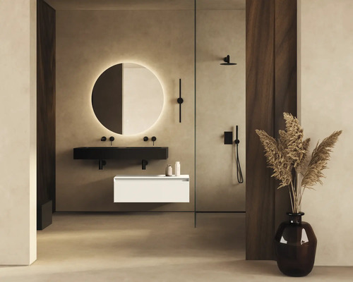 Modernt badrum med runda speglar och tvättställ