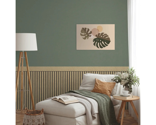 Vardagsrum med grön vägg, väggpaneler och en bild med löv