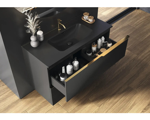 Svart tvättställsskåp med öppen låda i badrum