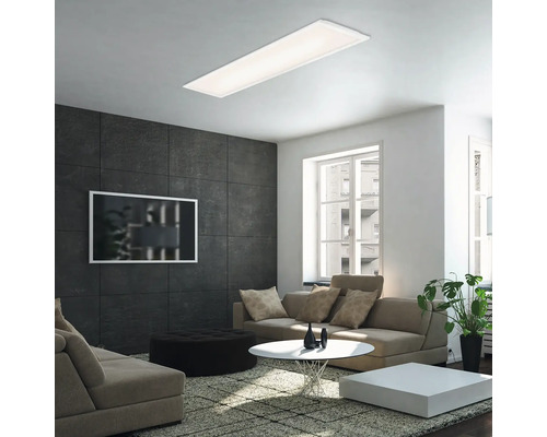 Vardagsrum med modern taklampa, soffa och soffbord.