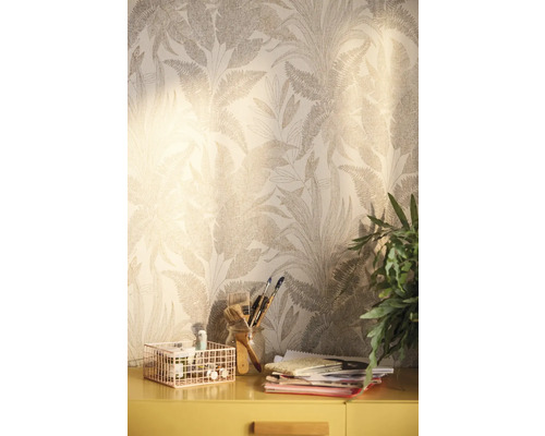 Scen med mönstrad tapet, skrivbord, växter och konstnärsmaterial