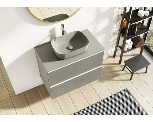 Grått tvättställ med handfat och två lådor i badrummet