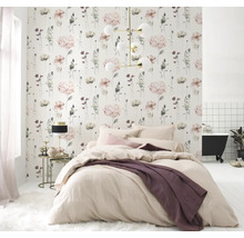 Ljust sovrum med blommig tapet, säng och badkar i bakgrunden