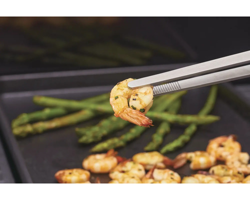 Grillade räkor med sparris, serveras med grilltång.