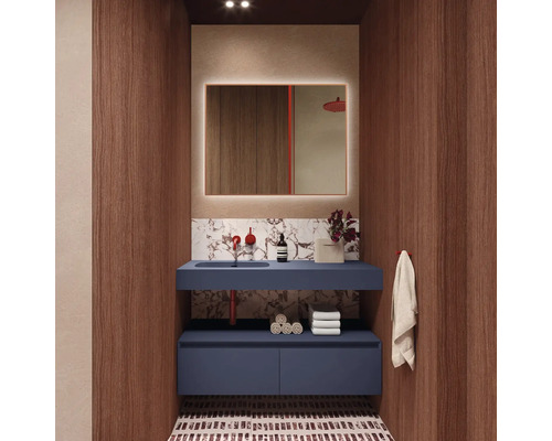 Modernt badrum med blått tvättställsskåp, upplyst spegel och träpaneler