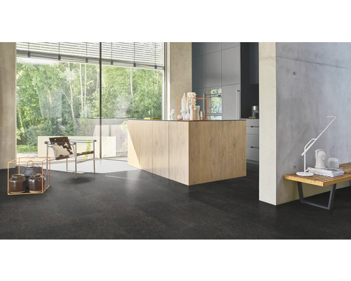 Ljust, modernt rum med stort fönster, köksö och mörkt golv