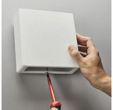 Montering av en fyrkantig vägglampa med en skruvmejsel