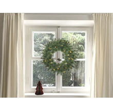 Juldekoration med fönster, gardiner, julkrans med belysning och liten julgran
