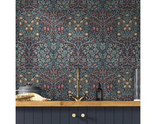 Dekorativt rum med blommönstrad tapet, diskbänksblandare och köksredskap på en trähylla.