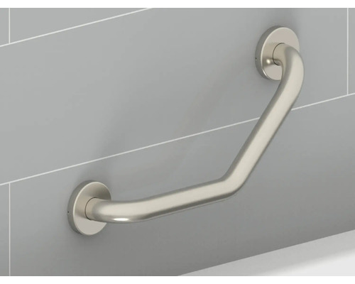 Metalliskt stödhandtag fäst på en vägg