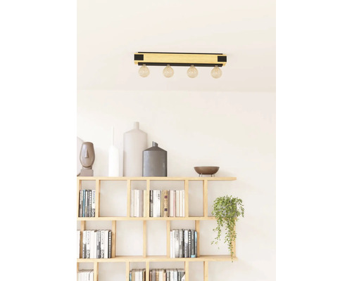 Taklampa med fyra glödlampor ovanför en bokhylla
