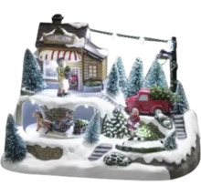 Dekorativ julscen med figurer, hus, julgranar och belysning