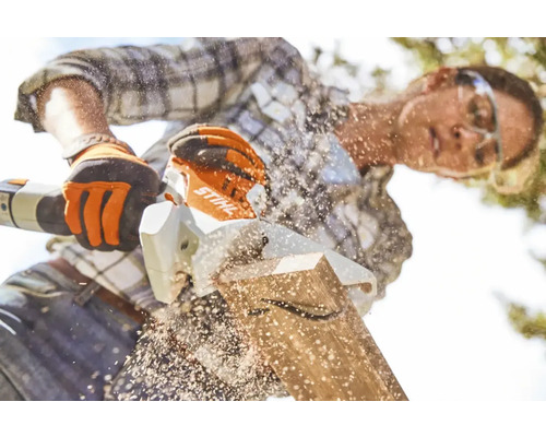 En person sågar en träplanka med en Stihl-såg.