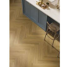 Läggning av träimitation klinker i fiskbensmönster i ett kök.