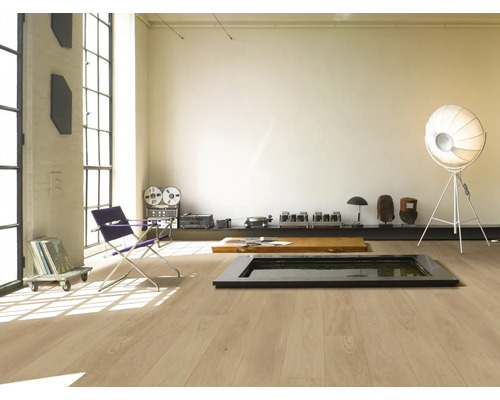 Ljust rum med trägolv, fåtölj och dekoration