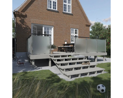 Terrass med trappa och insynsskydd framför ett tegelhus.