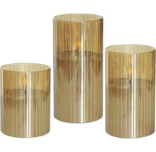 Tre ribbade cylindriska glas med LED-ljus