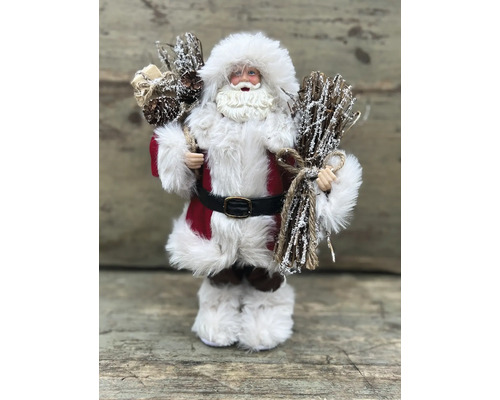 Dekorativ jultomte med grenar i handen som juldekoration