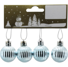 Fyra ljusblå räfflade julgranskulor på gyllene kartong