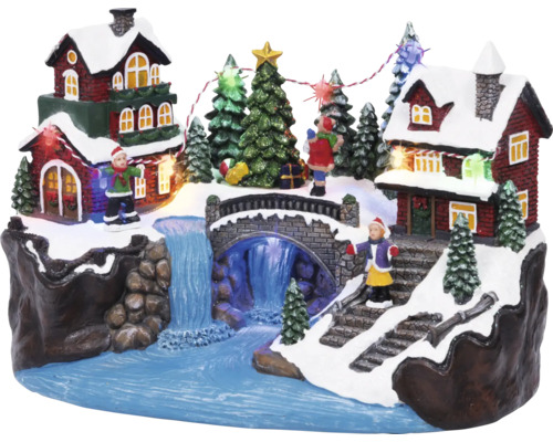 Juldekoration med hus, bro, vattenfall, träd och figurer Juldekoration med hus, bro, vattenfall, träd och figurer