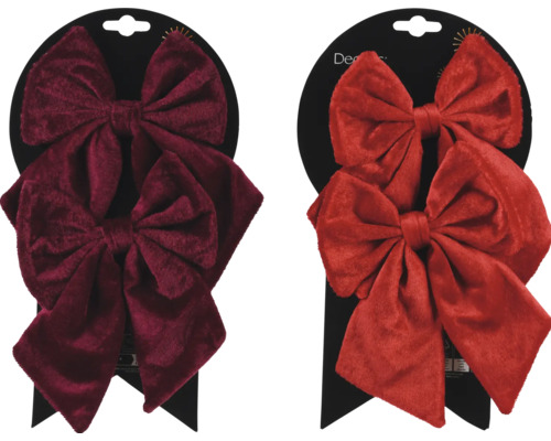 Två dekorativa sammetsrosetter på en detaljhandelsförpackning